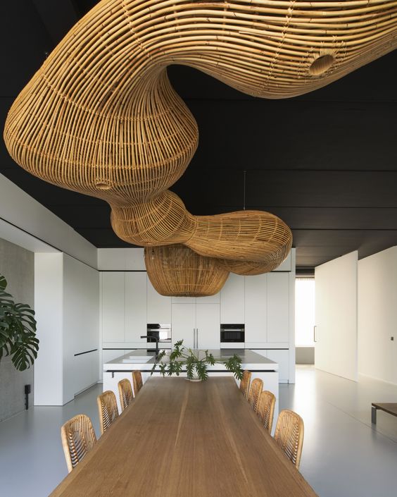 Sculptural rattan pendant lighting over a long dining table
