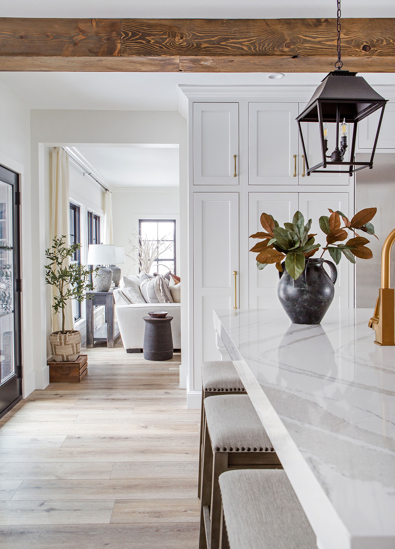 Full-height cabinetry and a single lantern drawing the eye upward Full-height cabinetry and a single lantern drawing the eye upward
