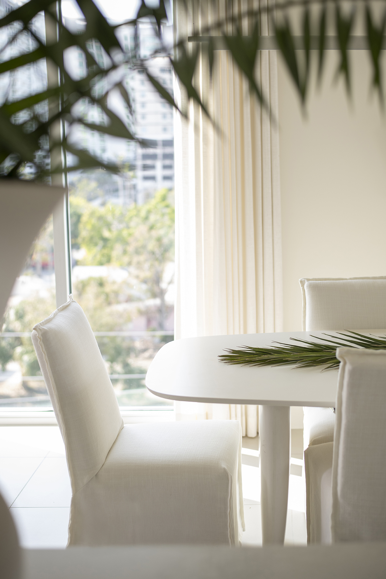 Styled dining table and chairs from the 332 Cocoanut project by Rachel Blindauer