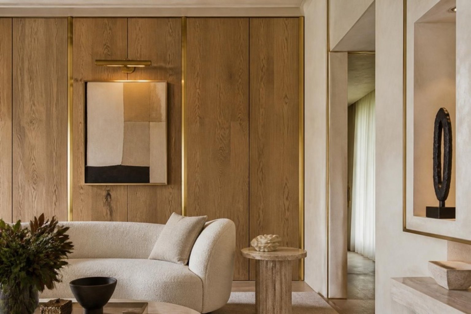 Refined reclaimed oak wall paneling with plaster walls and brass details