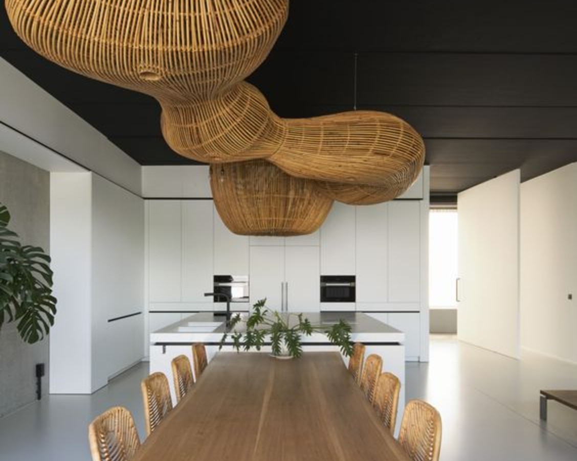 Sculptural rattan pendant lighting over a long dining table